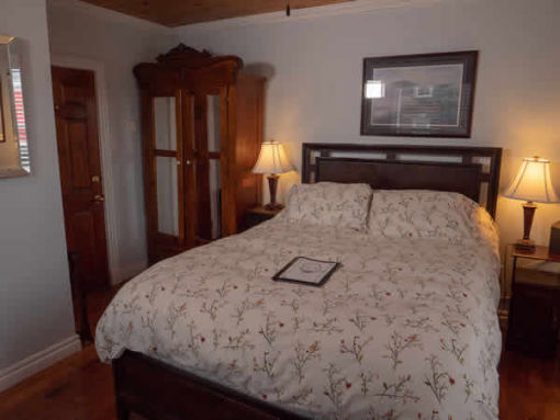 image: interior guest room with double bed from foot of bed