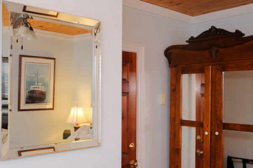 image: wall with mirror and wood cabinet