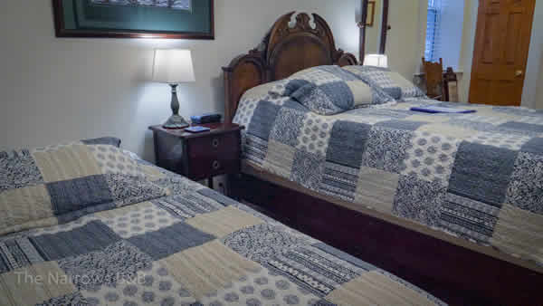 image: interior guest room view of bed from corner