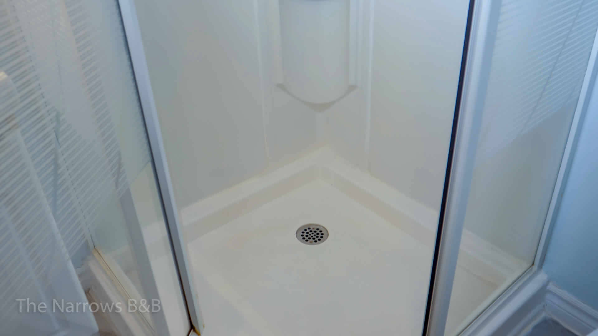 image: interior white stand up shower stall